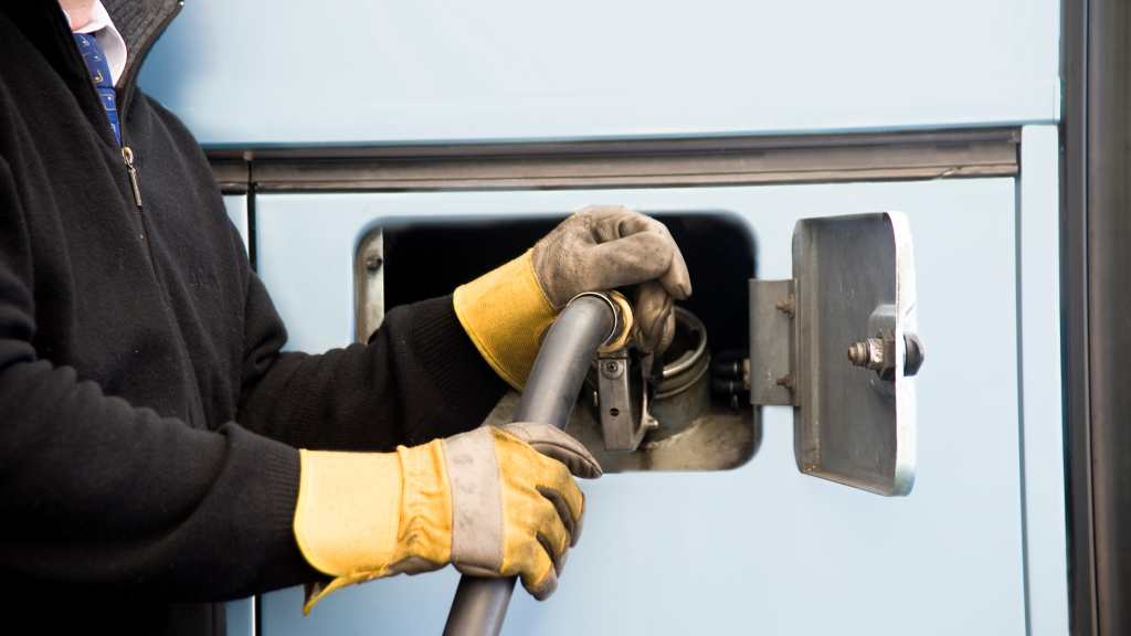 HGV driver fuelling up his lorry before a long haul journey.