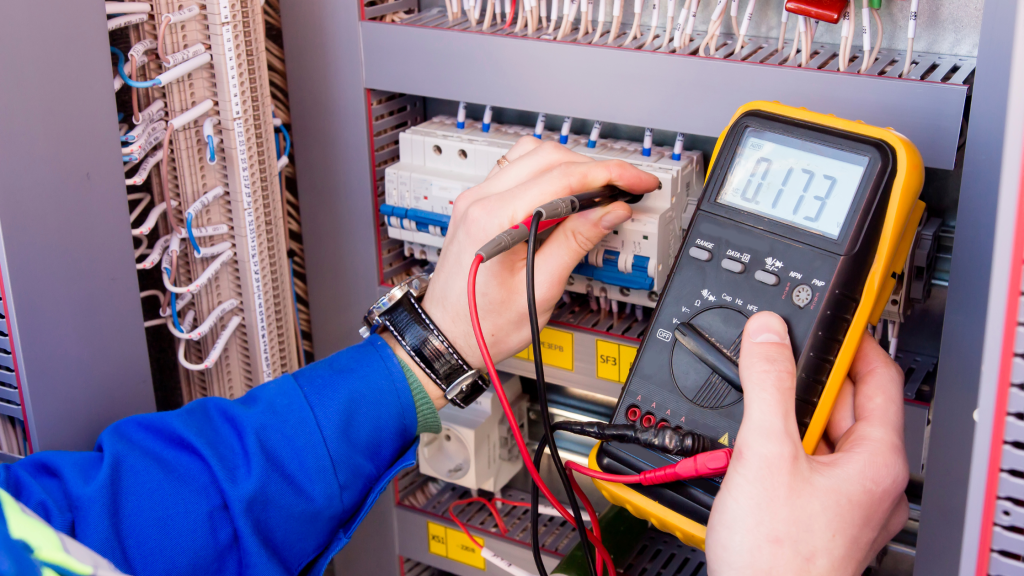 Telecoms engineer testing the voltage in a roadside cabinet.